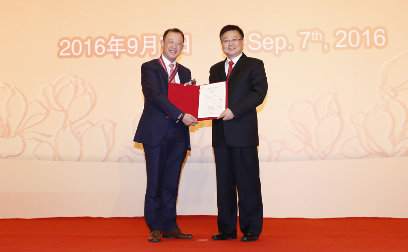 上海市政府外办主任张小松向张达授予“白玉兰纪念奖”奖牌和证书